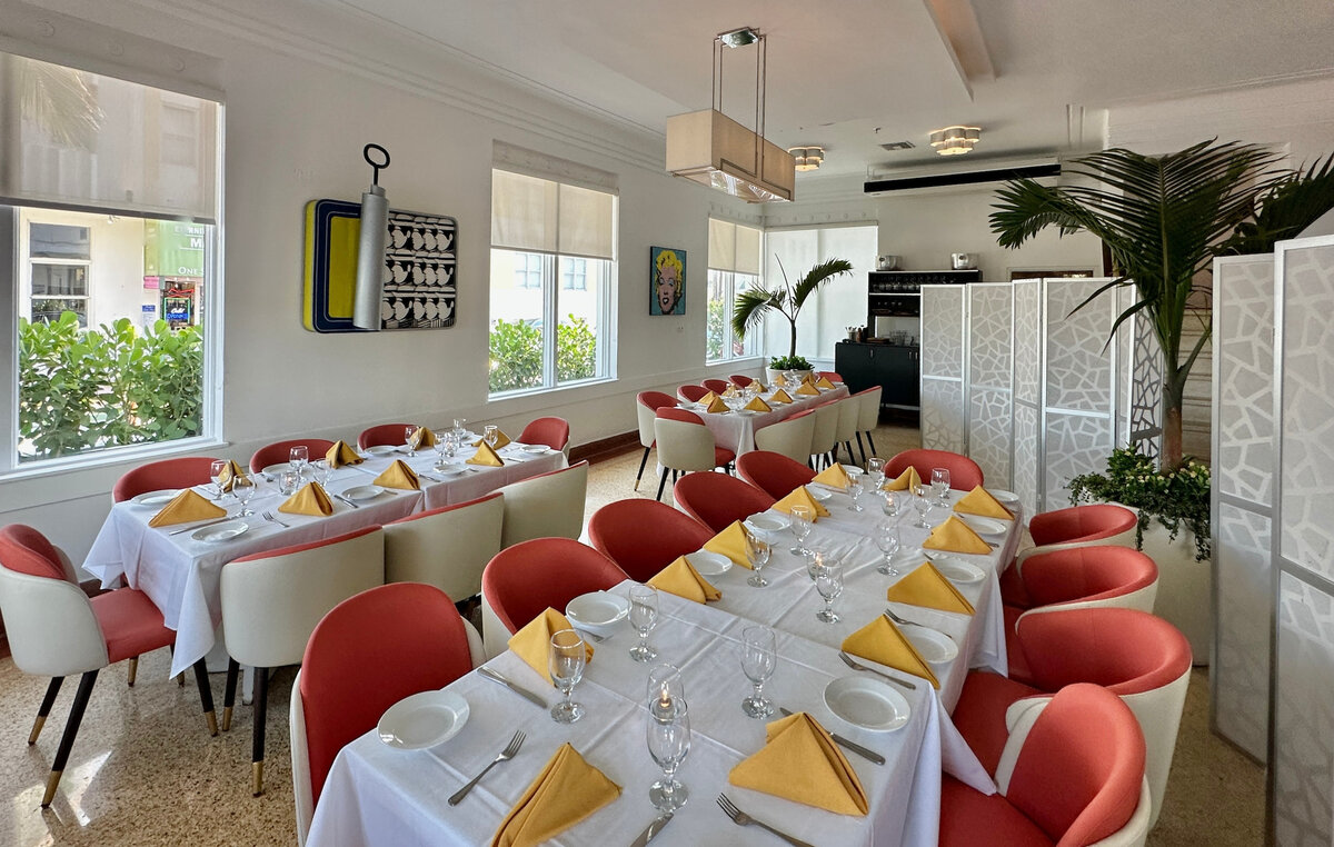 A dining room with several tables set for a meal